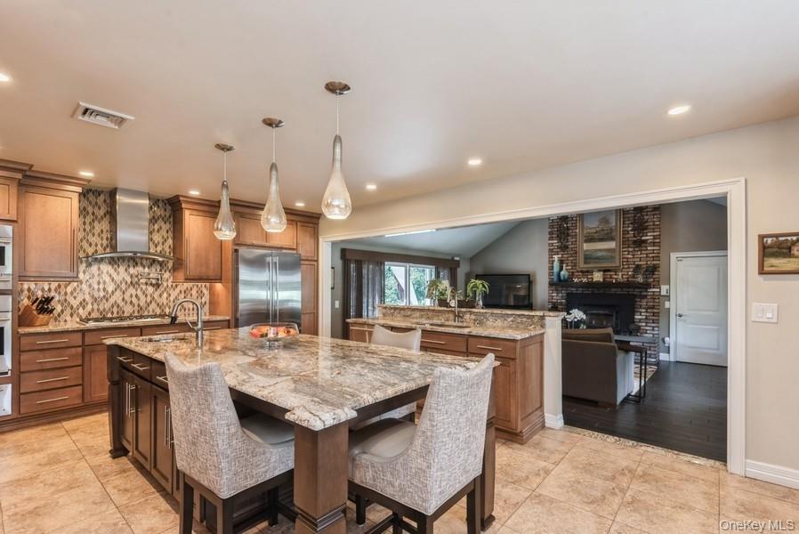 330 Private Road East Patchogue, NY 11772 - Photo 23 of 42 a kitchen with stainless steel appliances granite countertop a stove and a refrigerator