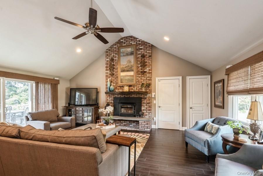 330 Private Road East Patchogue, NY 11772 - Photo 24 of 42 a living room with furniture a fireplace and a flat screen tv