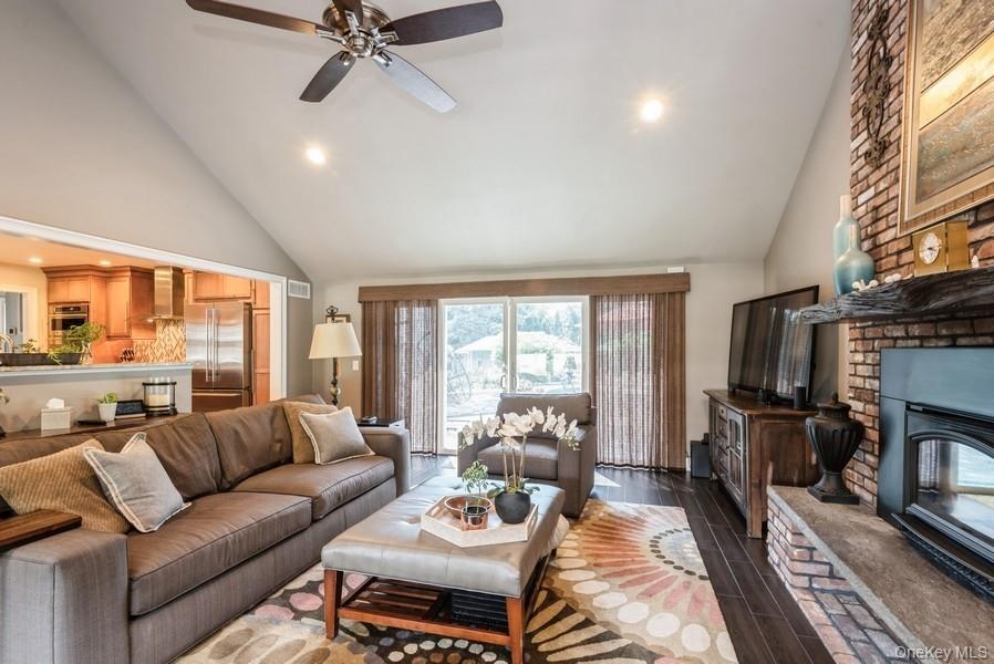 330 Private Road East Patchogue, NY 11772 - Photo 26 of 42 a living room with furniture a flat screen tv and a fireplace