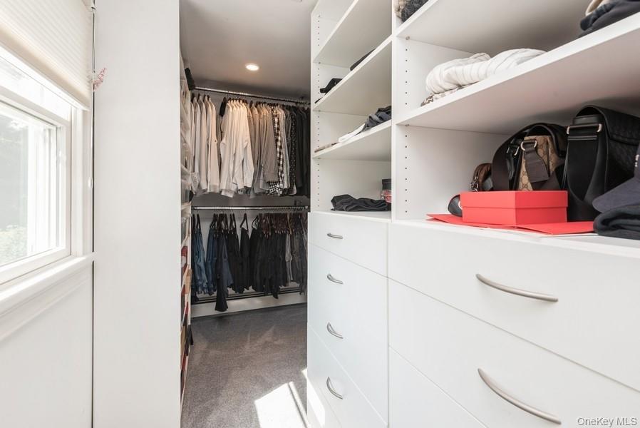 330 Private Road East Patchogue, NY 11772 - Photo 32 of 42 a view of walk in closet with clothes and shoes