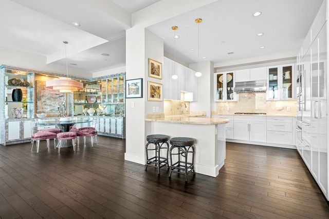 a kitchen with sink stove and cabinets
