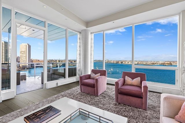 a living room with furniture and a floor to ceiling window