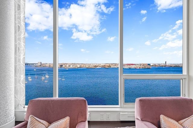 a living room with kitchen island furniture and a large window