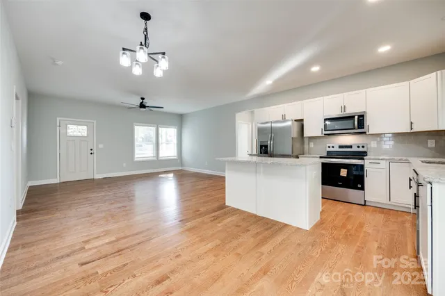 a view of kitchen with microwave and cabinets