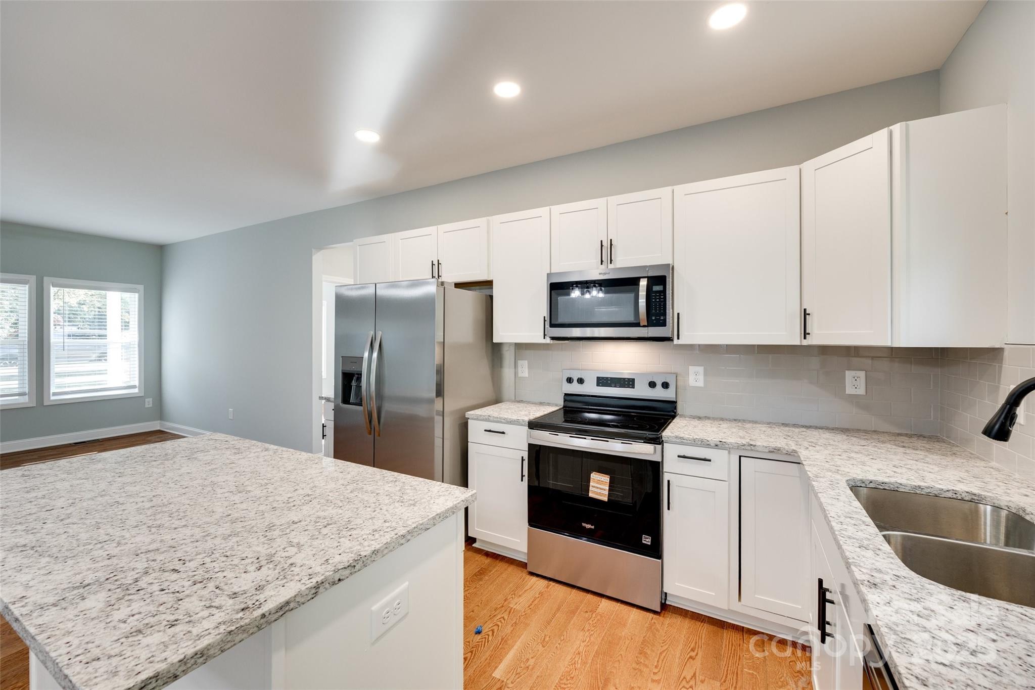 171 William Street York, SC 29745 - Photo 15 of 28 a kitchen with granite countertop white cabinets and stainless steel appliances