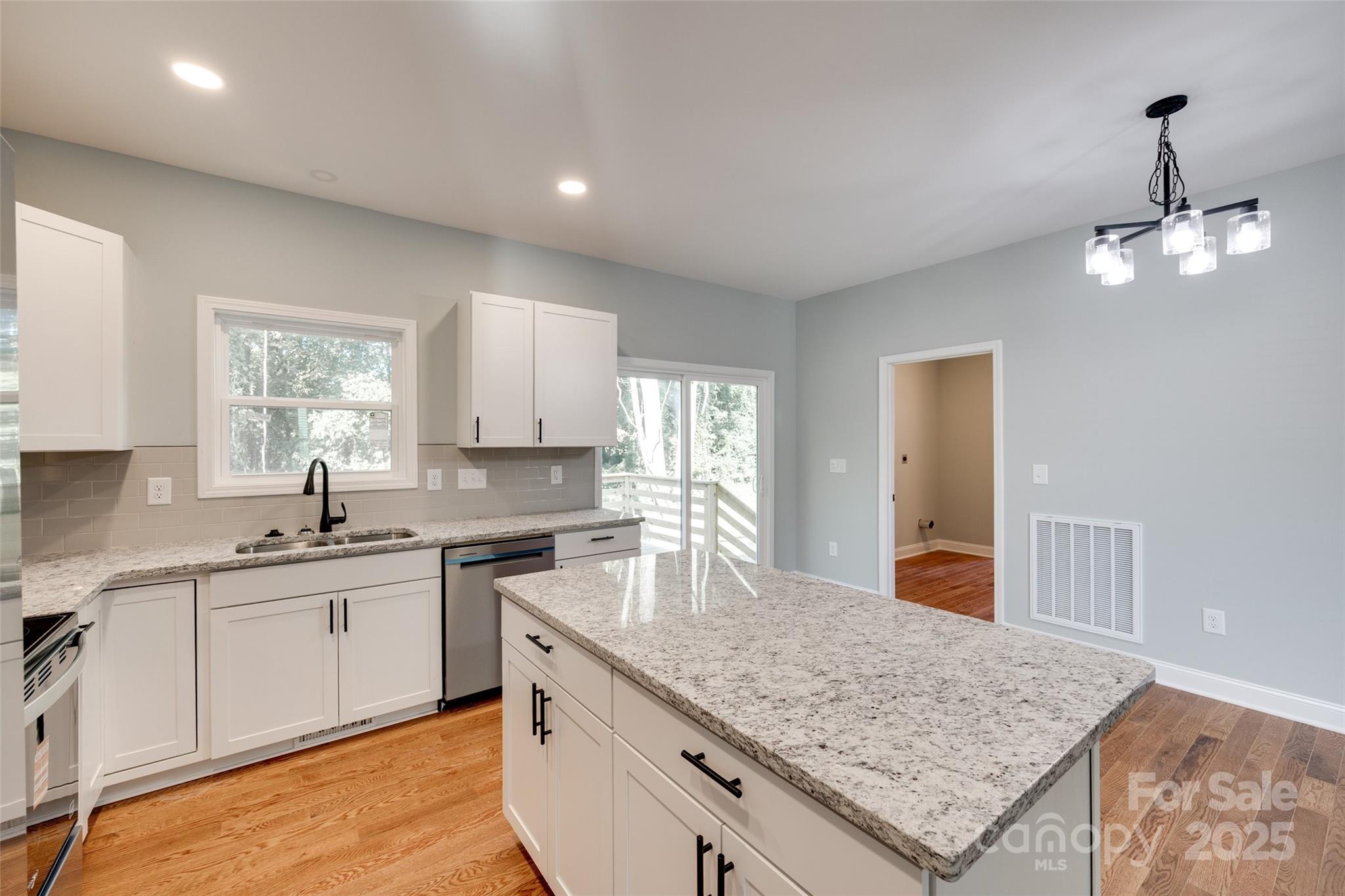171 William Street York, SC 29745 - Photo 17 of 28 a kitchen with a sink a center island cabinets and a window