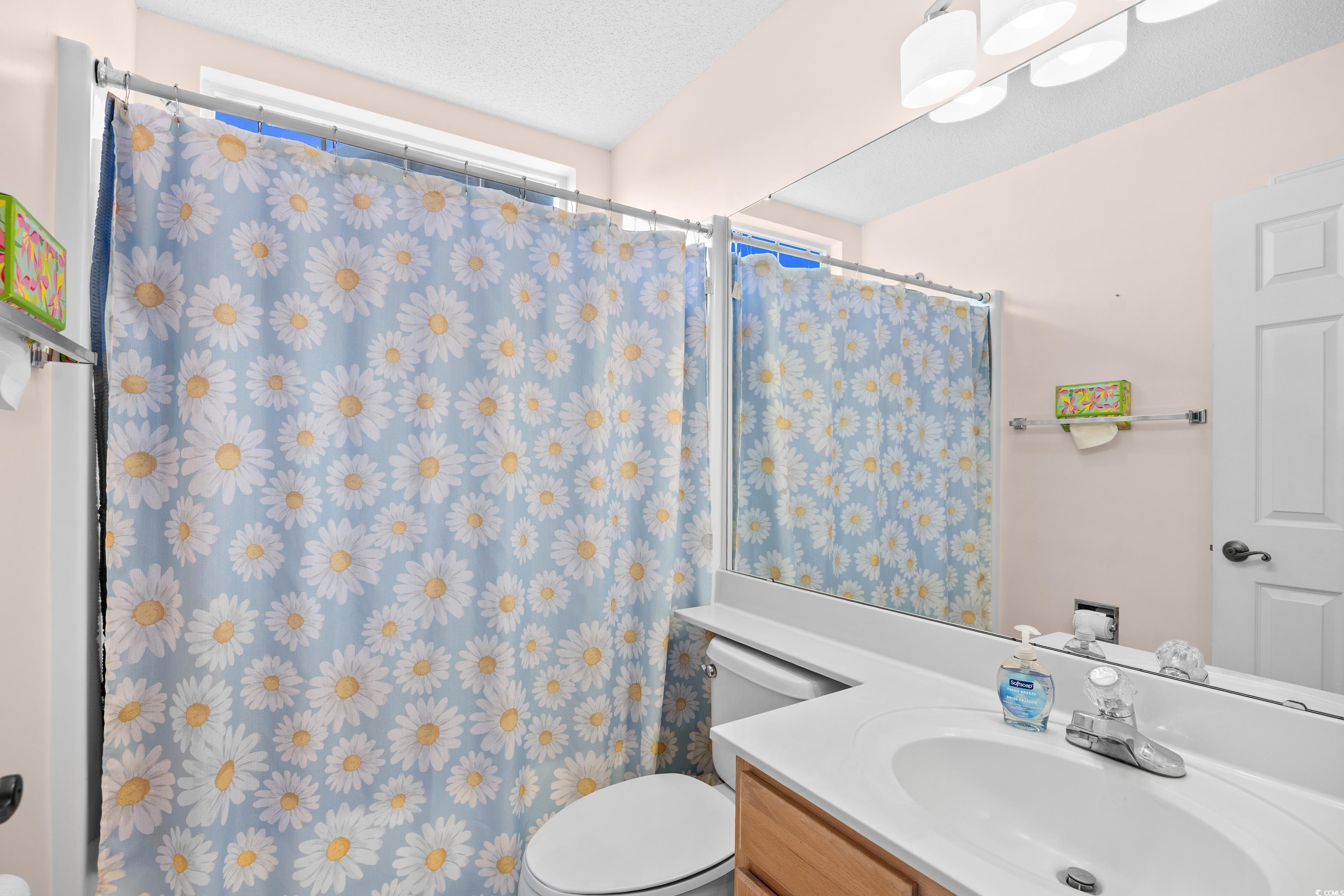 1744 Starbridge Drive Surfside Beach, SC 29575 - Photo 25 of 38 Full bathroom with a shower with shower curtain, vanity, and a textured ceiling
