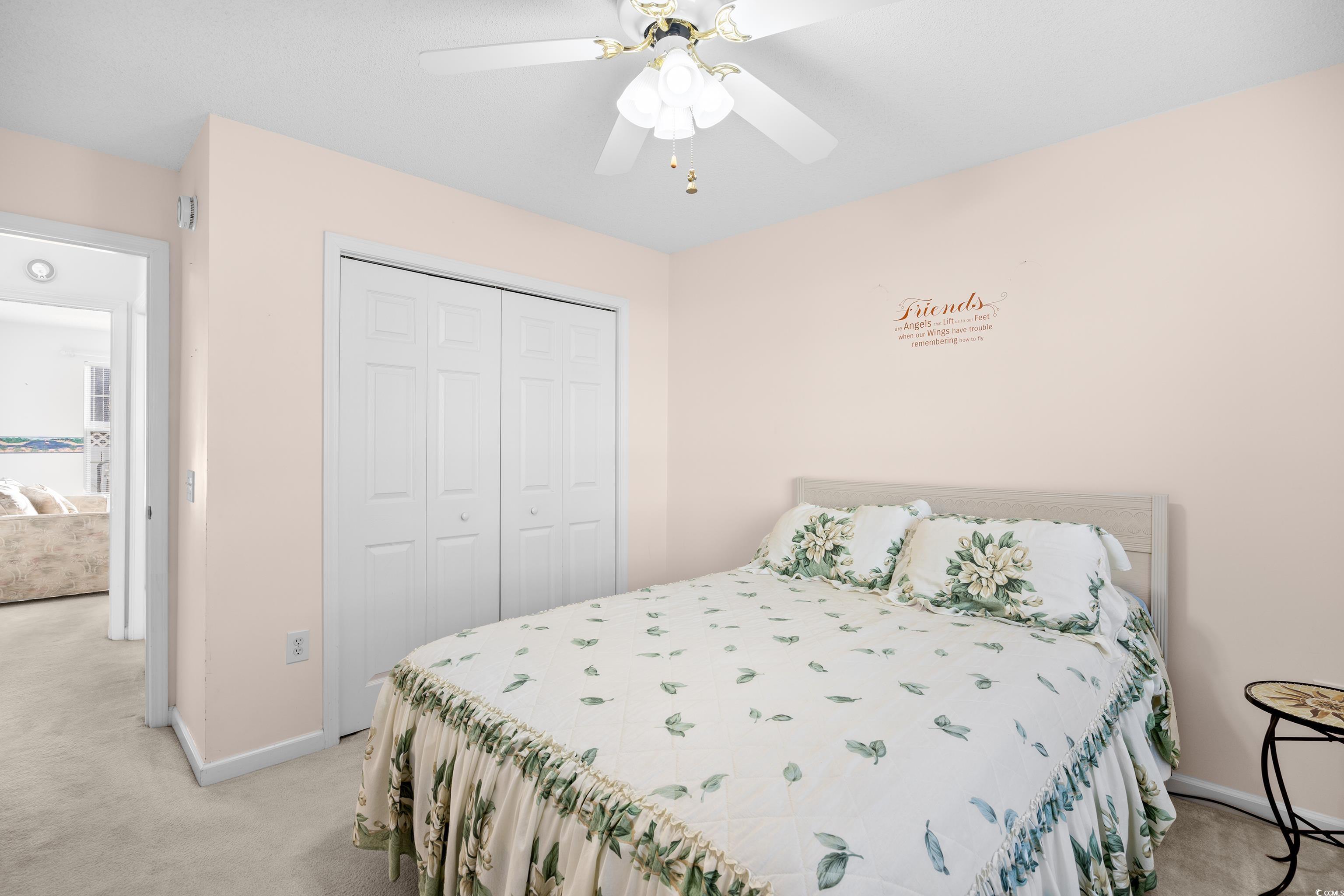 1744 Starbridge Drive Surfside Beach, SC 29575 - Photo 27 of 38 Bedroom featuring light carpet, a closet, and a ceiling fan