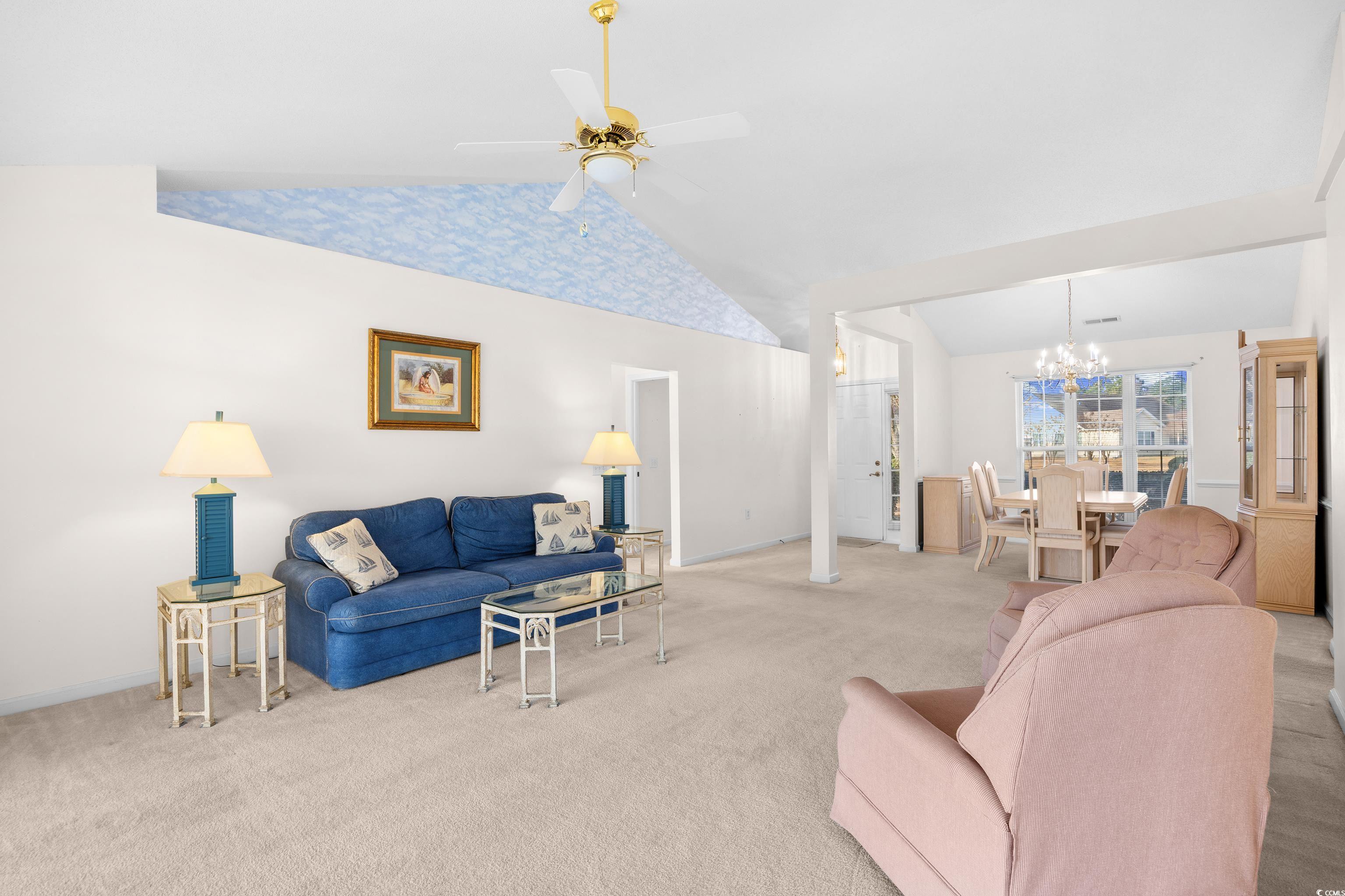 1744 Starbridge Drive Surfside Beach, SC 29575 - Photo 4 of 38 Carpeted living room featuring a chandelier, lofted ceiling, and a ceiling fan