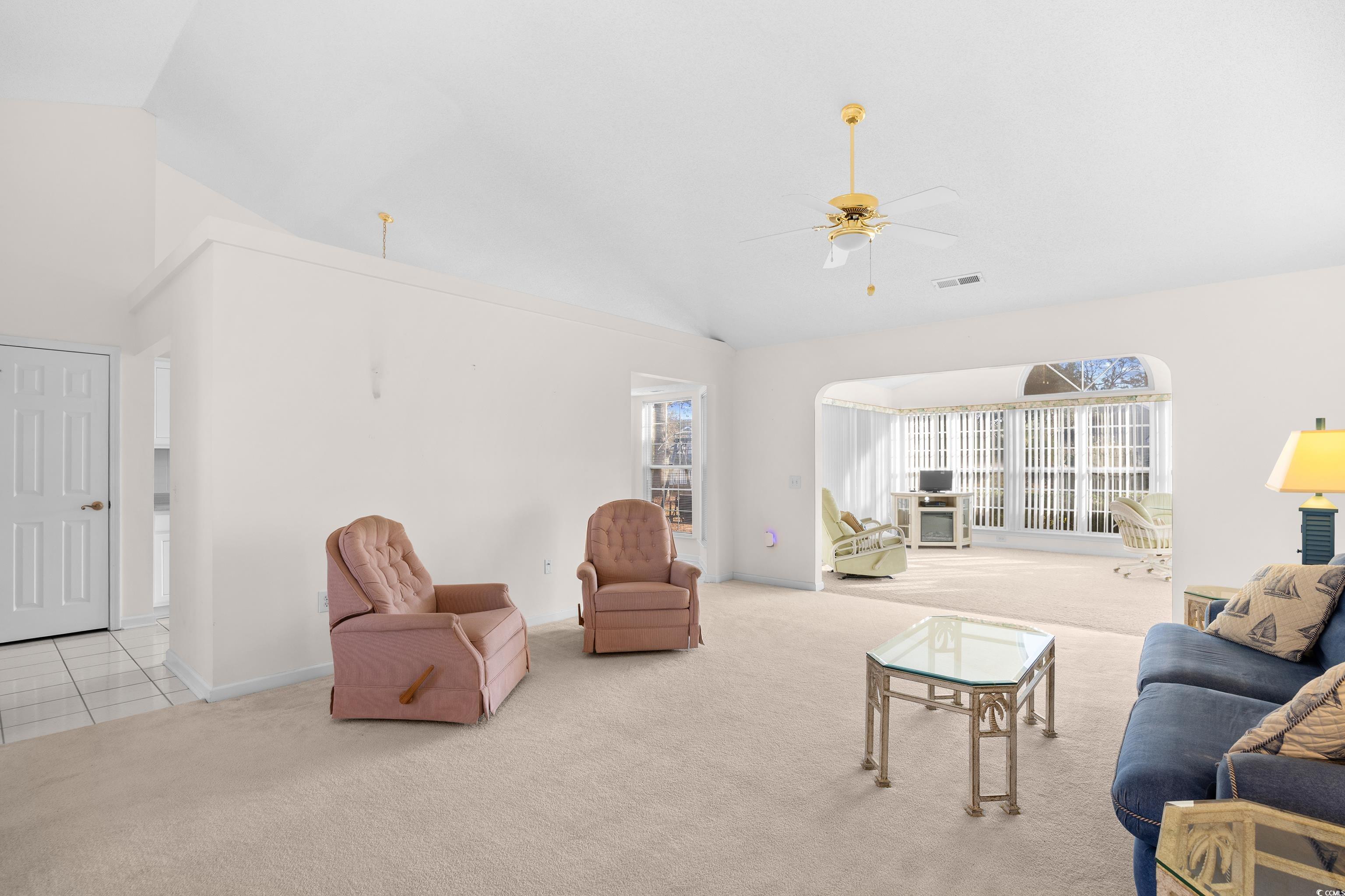 1744 Starbridge Drive Surfside Beach, SC 29575 - Photo 7 of 38 Carpeted living area featuring ceiling fan and high vaulted ceiling