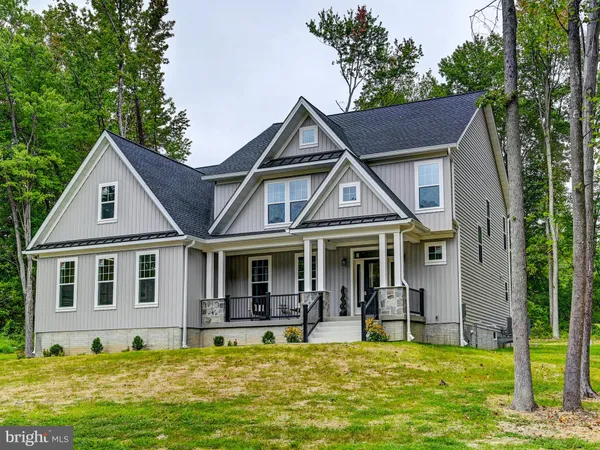 a view of a house with swimming pool next to a yard