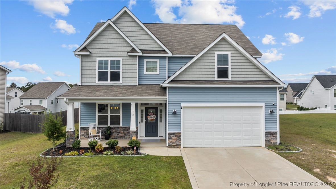 a front view of a house with a yard and outdoor seating