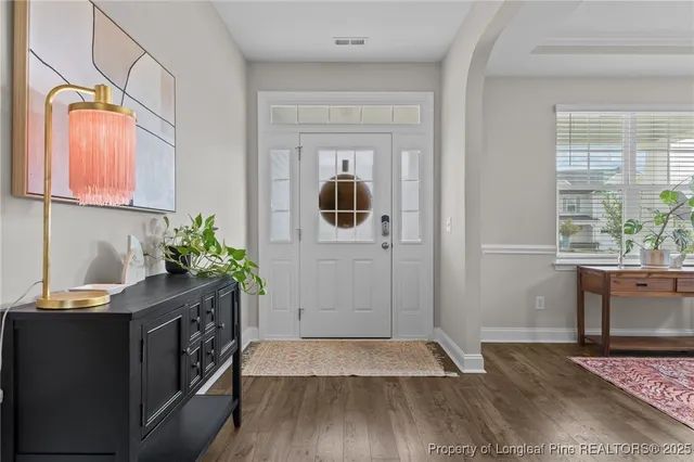 a living room with furniture a chandelier and a rug
