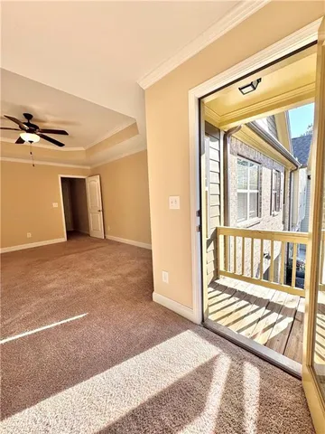 a view of an empty room with wooden floor and windows