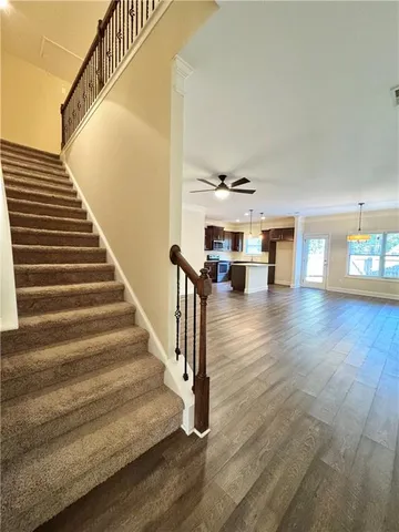 a view of entryway and hall with wooden floor