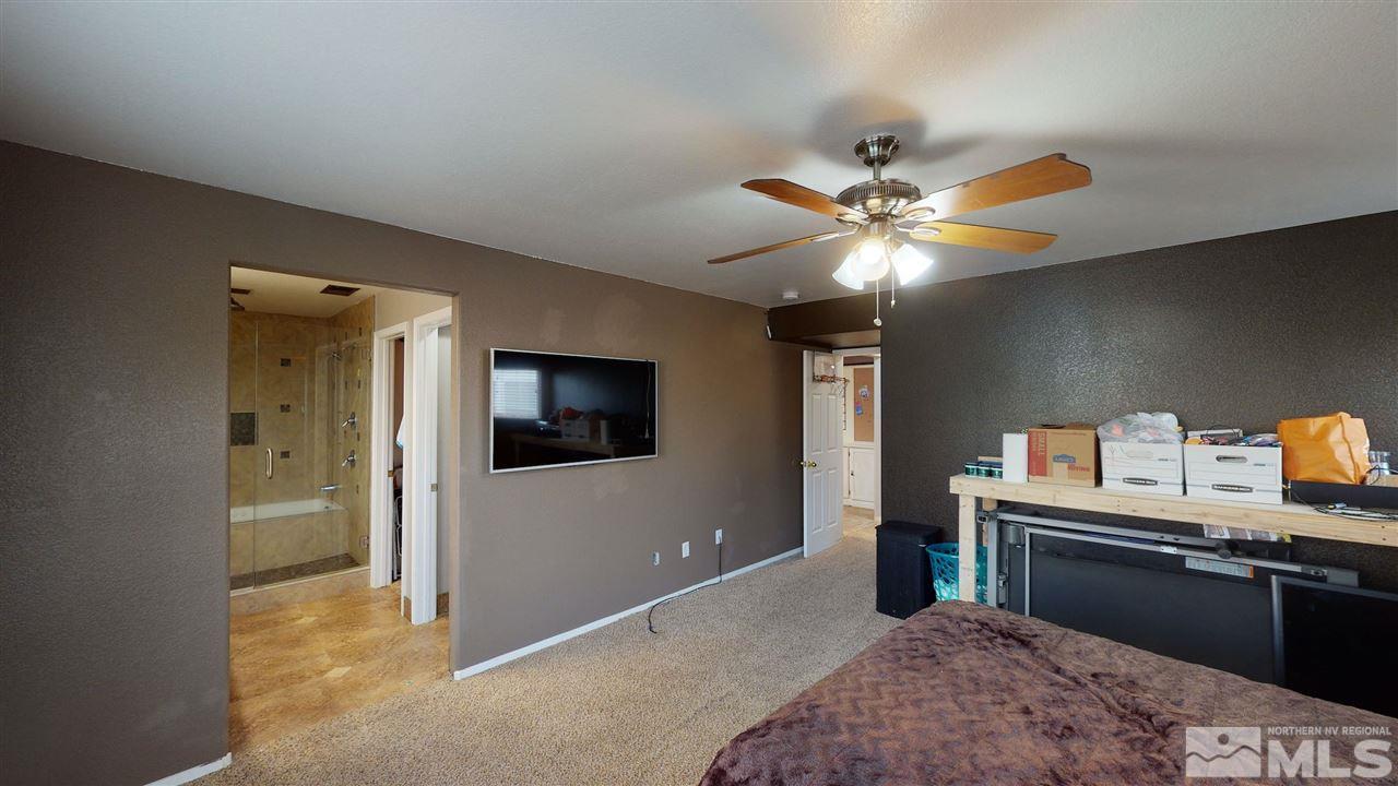8900 Griffon Court Reno, NV 89506 - Photo 21 of 29 a bedroom with furniture and a flat screen tv