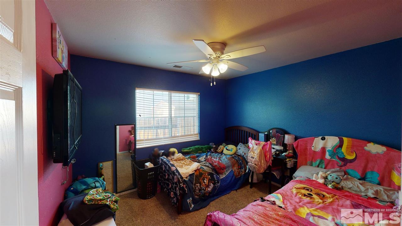 8900 Griffon Court Reno, NV 89506 - Photo 25 of 29 a bedroom with two beds and a chandelier