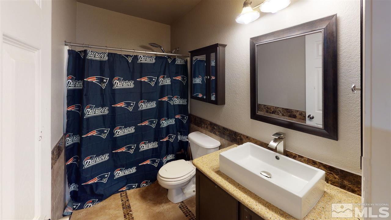 8900 Griffon Court Reno, NV 89506 - Photo 6 of 29 a bathroom with a toilet sink and mirror
