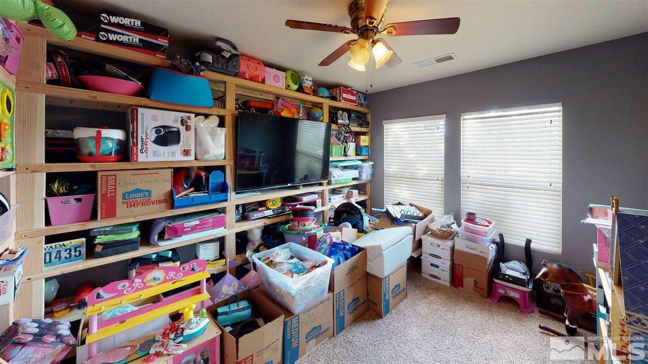8900 Griffon Court Reno, NV 89506 - Photo 7 of 29 a room with furniture toys and a flat screen tv