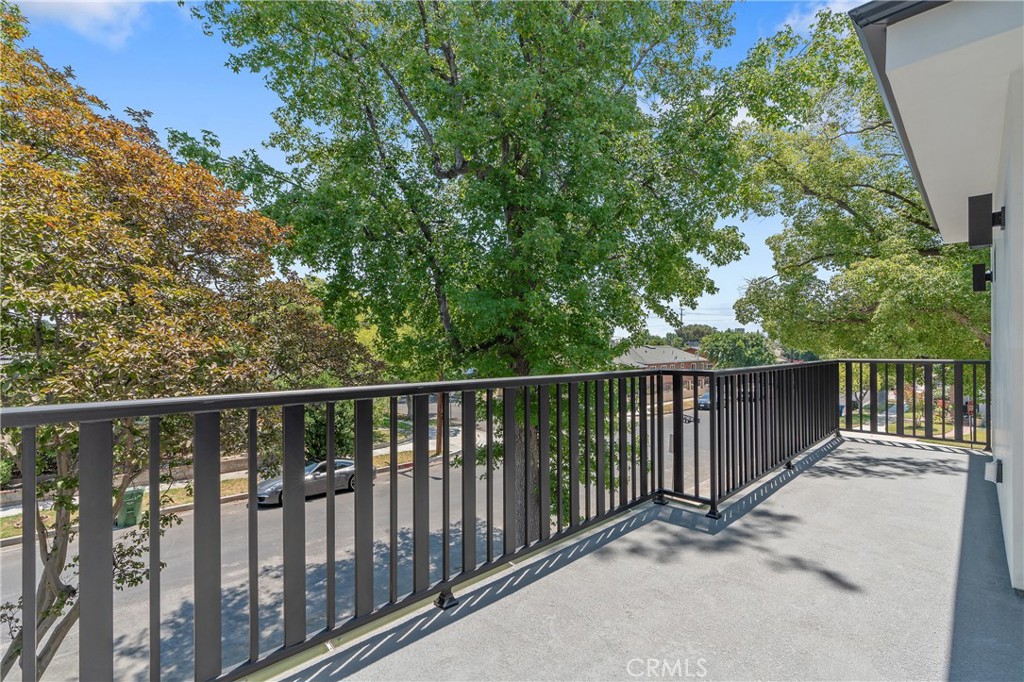a balcony with wooden floor and fence