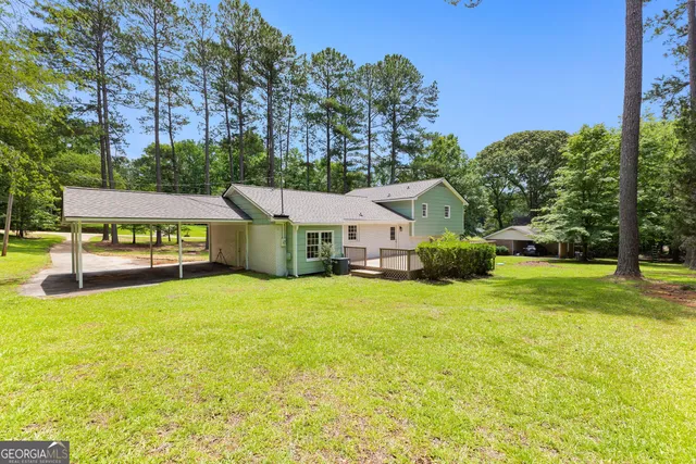 a view of house with outdoor space and swimming pool