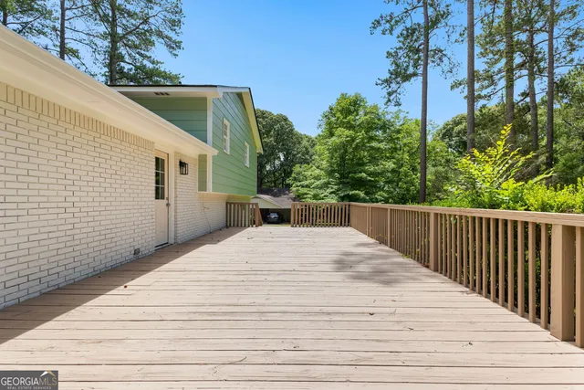 a view of a house with a wooden deck