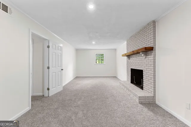 a view of an empty room with a fireplace