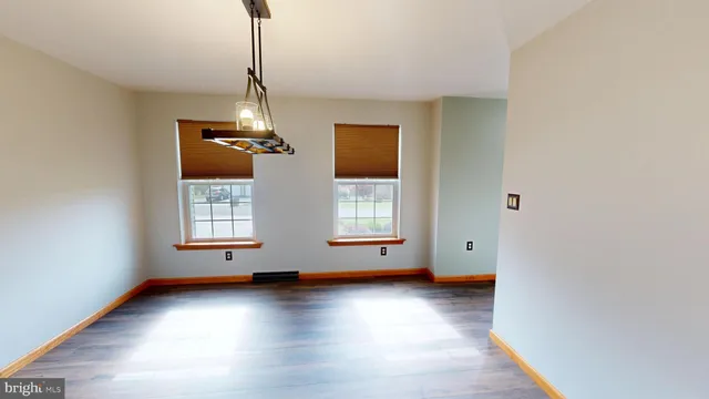 a kitchen with stainless steel appliances granite countertop refrigerator dining table and chairs