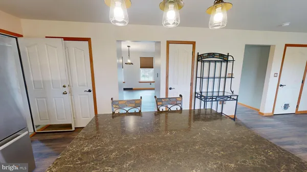 a view of a room with wooden floor and window