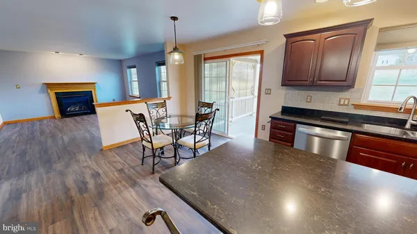 a view of empty room with window and ceiling fan