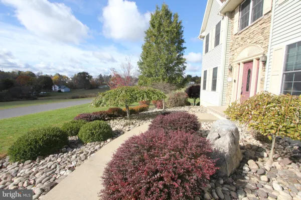 a view of a house with backyard porch and sitting area