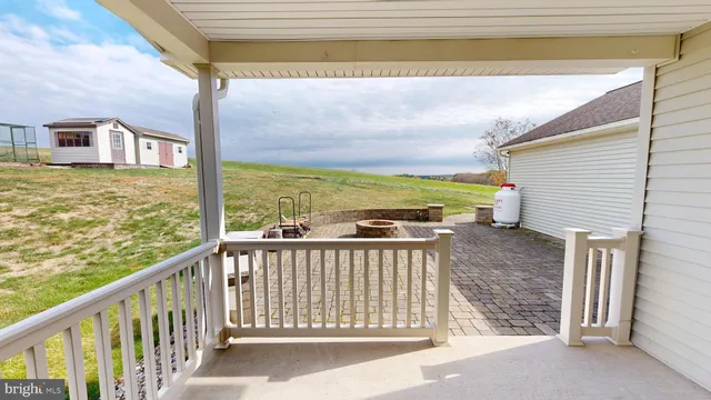 an empty room with a ceiling fan and bathroom view