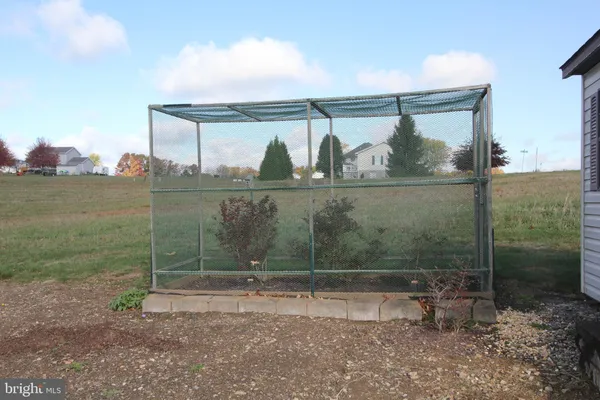 a view of a room with wooden floor staircase and a window
