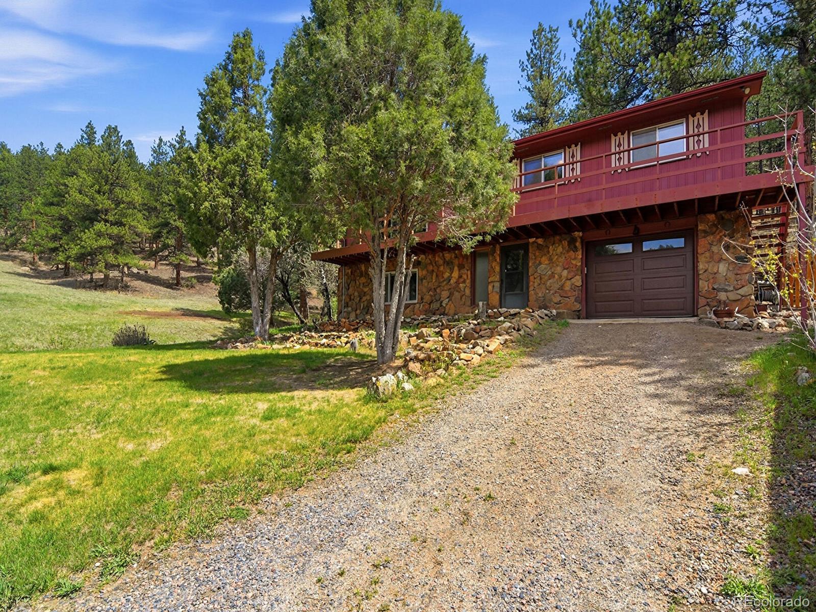 2830 Kerr Gulch Road Evergreen, CO 80439 - Photo 3 of 48 a view of a house with a yard