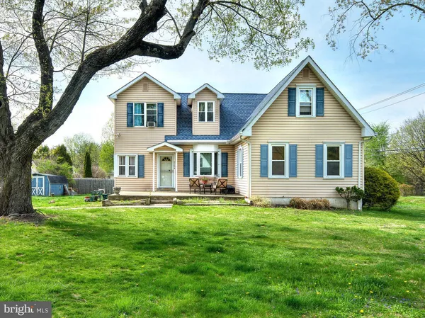 a front view of a house with a garden and yard