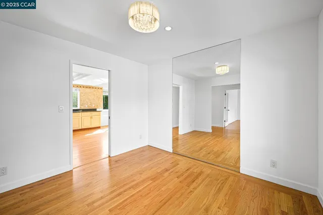 a kitchen with stainless steel appliances granite countertop a stove a refrigerator and a wooden floor