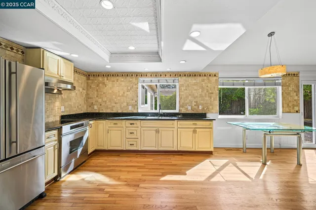 a living room with furniture fireplace and a large window