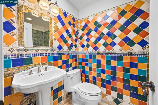 an aerial view of a house with swimming pool and large trees