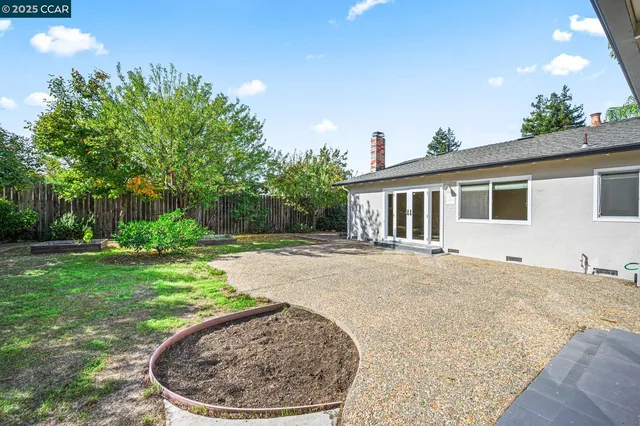 an aerial view of a city with lots of residential buildings and mountain view in back