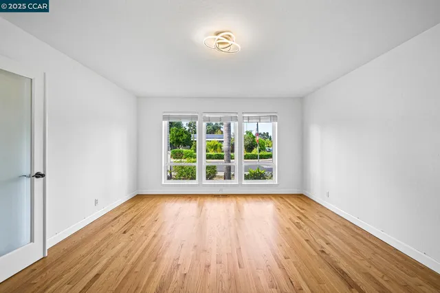 a view of an empty room and wooden floor