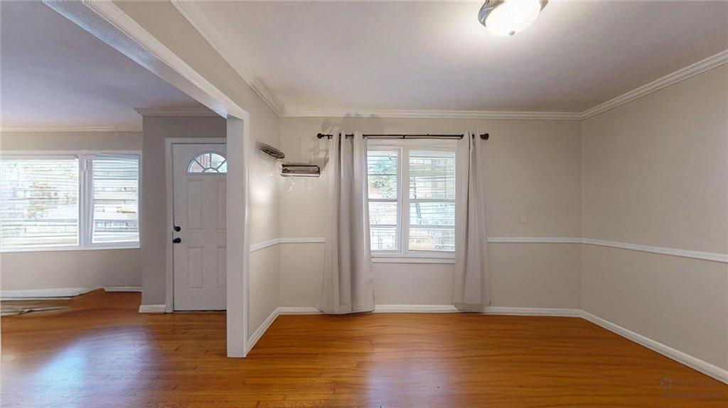 1838 Bruce Road Northeast Atlanta, GA 30329 - Photo 15 of 59 an empty room with wooden floor and windows