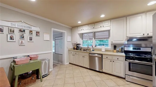 a kitchen with stainless steel appliances granite countertop a refrigerator and a sink