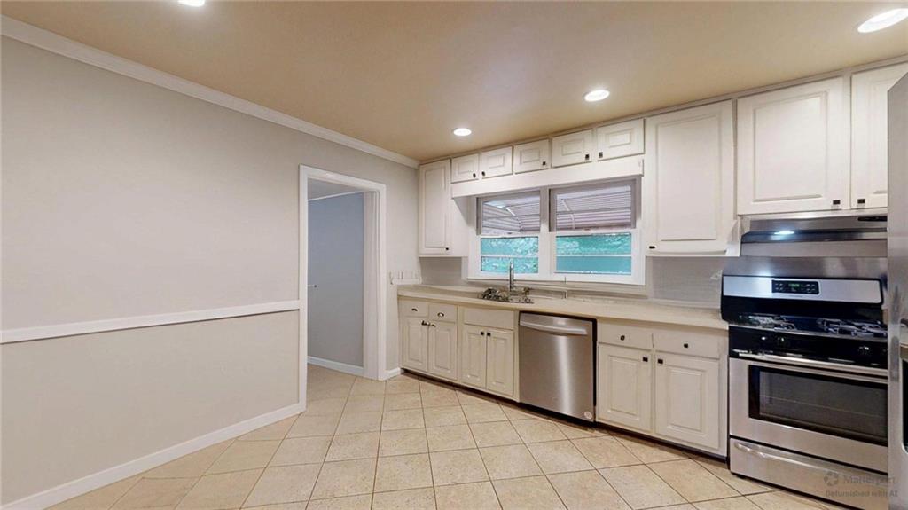 1838 Bruce Road Northeast Atlanta, GA 30329 - Photo 17 of 59 a kitchen with stainless steel appliances granite countertop a stove and a sink