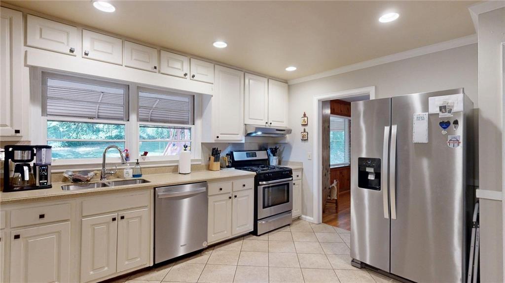 1838 Bruce Road Northeast Atlanta, GA 30329 - Photo 20 of 59 a kitchen with stainless steel appliances granite countertop a refrigerator and a sink