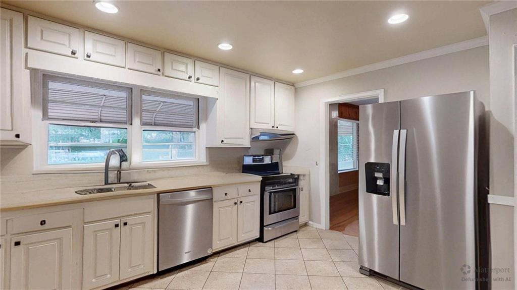 1838 Bruce Road Northeast Atlanta, GA 30329 - Photo 21 of 59 a kitchen with granite countertop a refrigerator and a sink