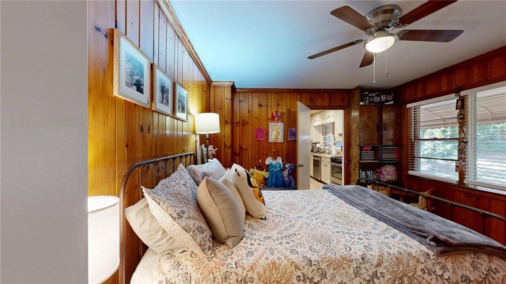 1838 Bruce Road Northeast Atlanta, GA 30329 - Photo 31 of 59 a bedroom with a bed next to a window and a chandelier