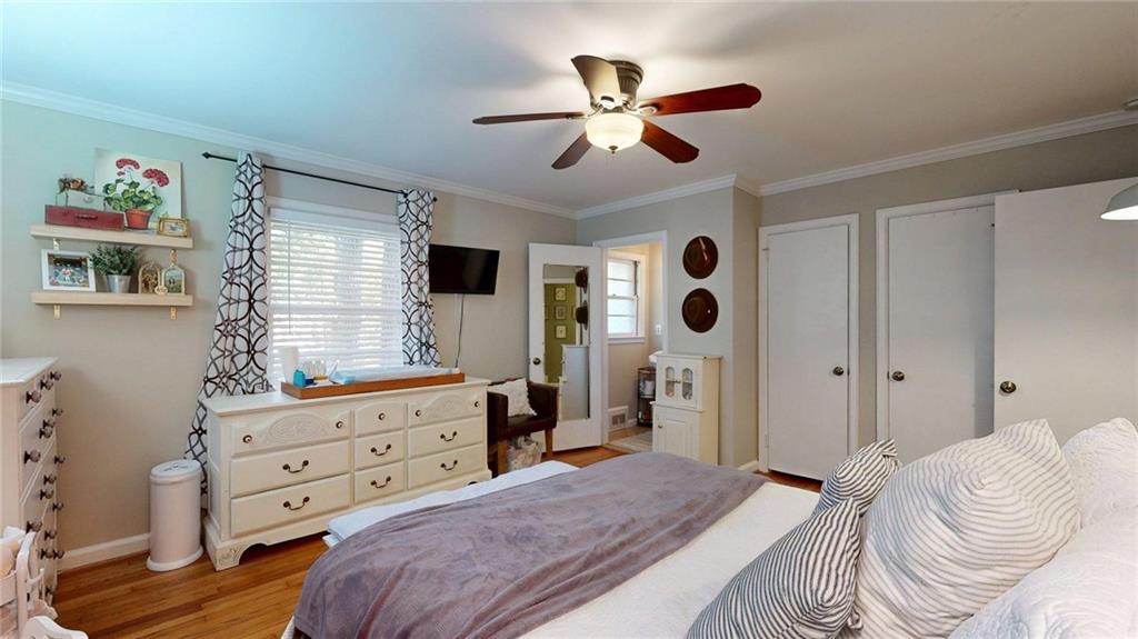 1838 Bruce Road Northeast Atlanta, GA 30329 - Photo 35 of 59 a bedroom with a bed and a chandelier