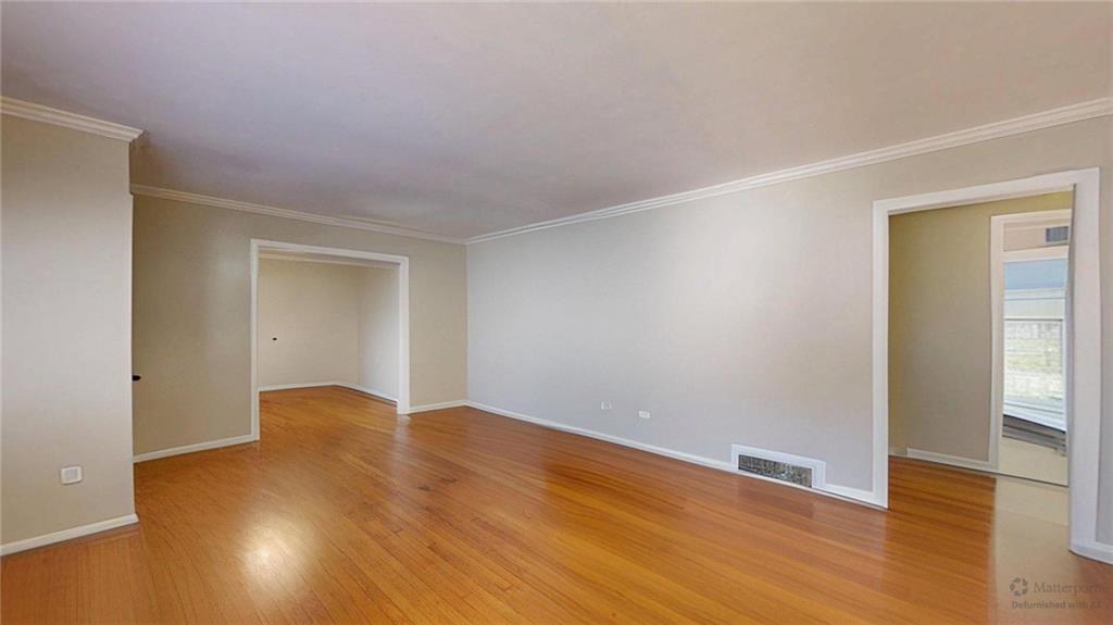 1838 Bruce Road Northeast Atlanta, GA 30329 - Photo 6 of 59 an empty room with wooden floor and windows with curtains