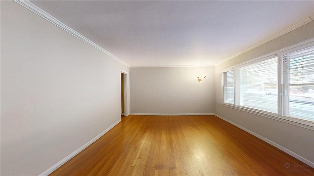 1838 Bruce Road Northeast Atlanta, GA 30329 - Photo 10 of 59 an empty room with wooden floor and windows