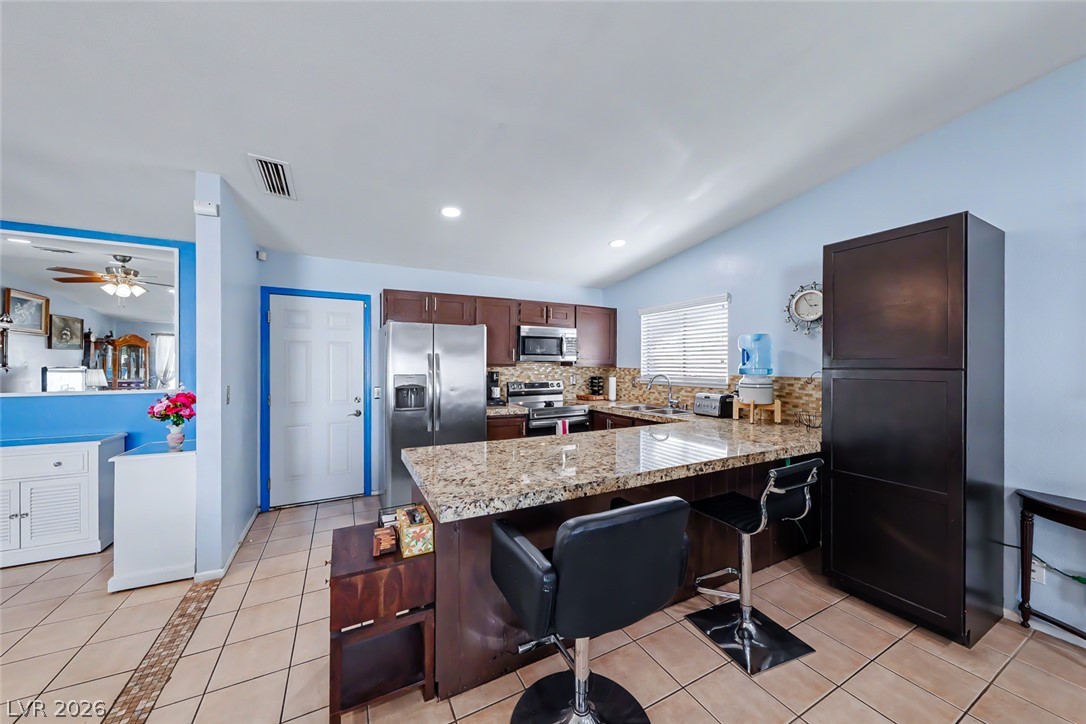 3107 Trueno Road Henderson, NV 89014 - Photo 14 of 37 A well-appointed kitchen features rich cabinetry, generous counter space, and integrated appliances.